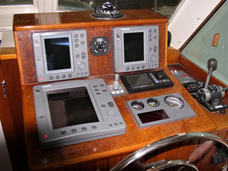 Slide: The Image of Control panel of a 2001 Mast & Mallet 38 Picnic Boat with navigation instruments. - 32