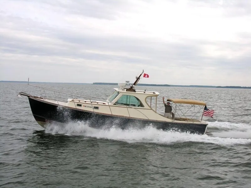 Slide: The Image of 2001 Mast & Mallet 38 Picnic Boat cruising on open water under cloudy skies. - 4