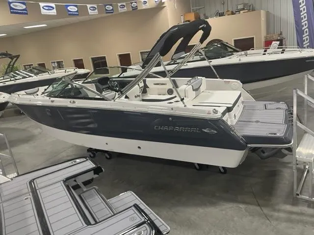 Slide: The Image of 2023 Chaparral 247 SSX boat in showroom, side view. - 2