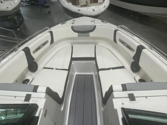Slide: The Image of 2023 Chaparral 247 SSX boat interior with white and gray seating. - 7
