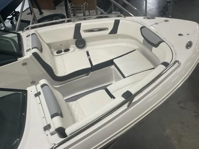 Slide: The Image of 2023 Chaparral 247 SSX boat interior with white and gray seating. - 8