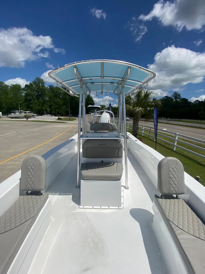 Slide: The Image of 2024 Savannah SS21 boat with T-top and seating, parked outdoors on a sunny day. - 13