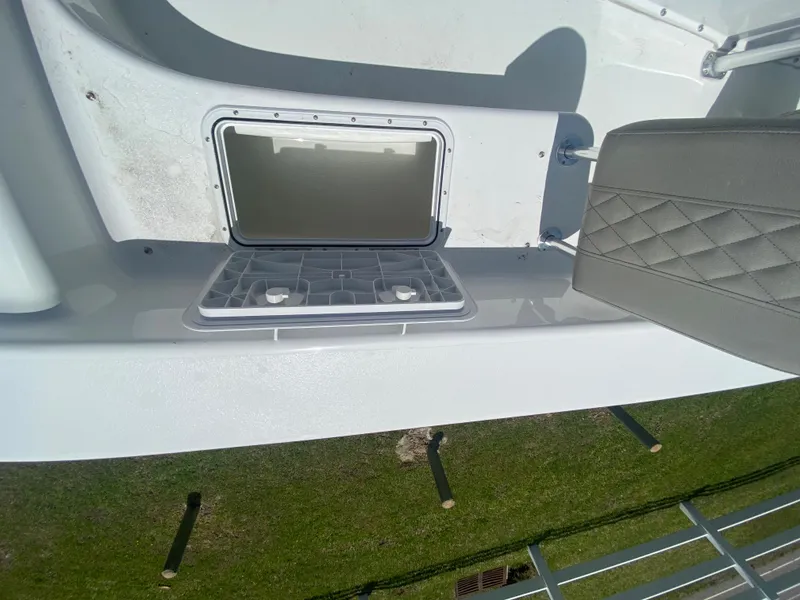 Slide: The Image of 2024 Savannah SS21 boat storage compartment with open hatch and cushioned seat. - 14
