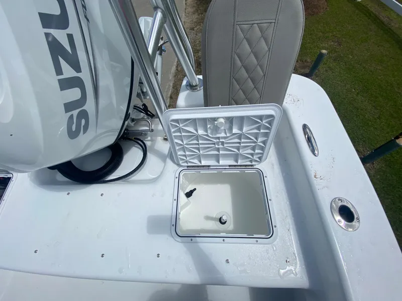 Slide: The Image of 2024 Savannah SS21 boat with open storage compartment and Suzuki engine. - 6