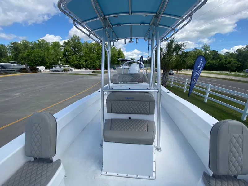 Slide: The Image of 2024 Savannah SS21 boat with blue canopy and cushioned seating. - 10