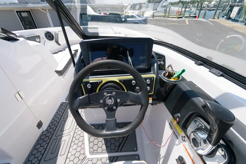 Slide: The Image of 2017 Scarab 255 HO Impulse boat cockpit with steering wheel and dashboard. - 11