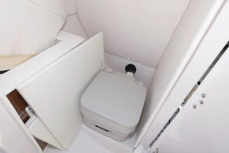 Slide: The Image of 2017 Scarab 255 HO Impulse boat interior with compact marine toilet. - 13