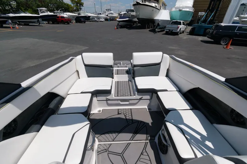 Slide: The Image of 2017 Scarab 255 HO Impulse boat interior with white seating at a marina. - 6