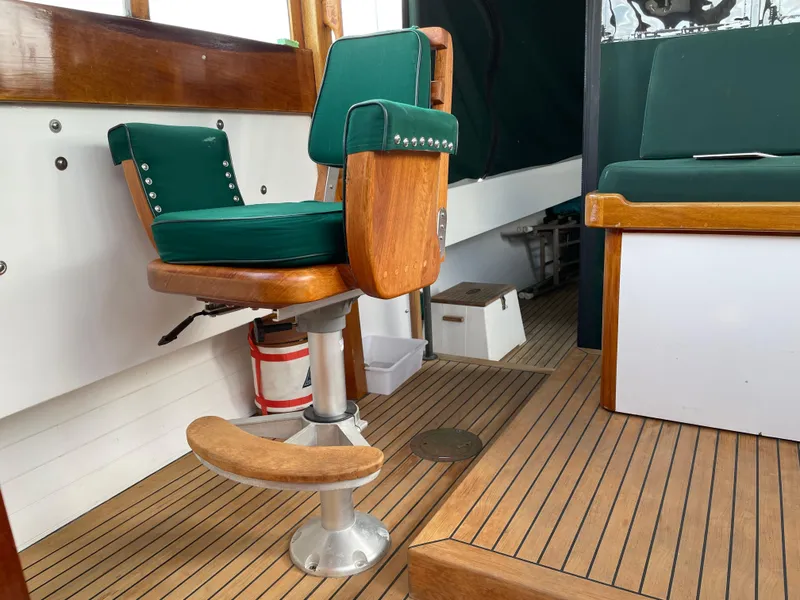 Slide: The Image of Interior of 1996 Downeast 36 Lobster Boat with green cushioned seating and wooden flooring. - 13