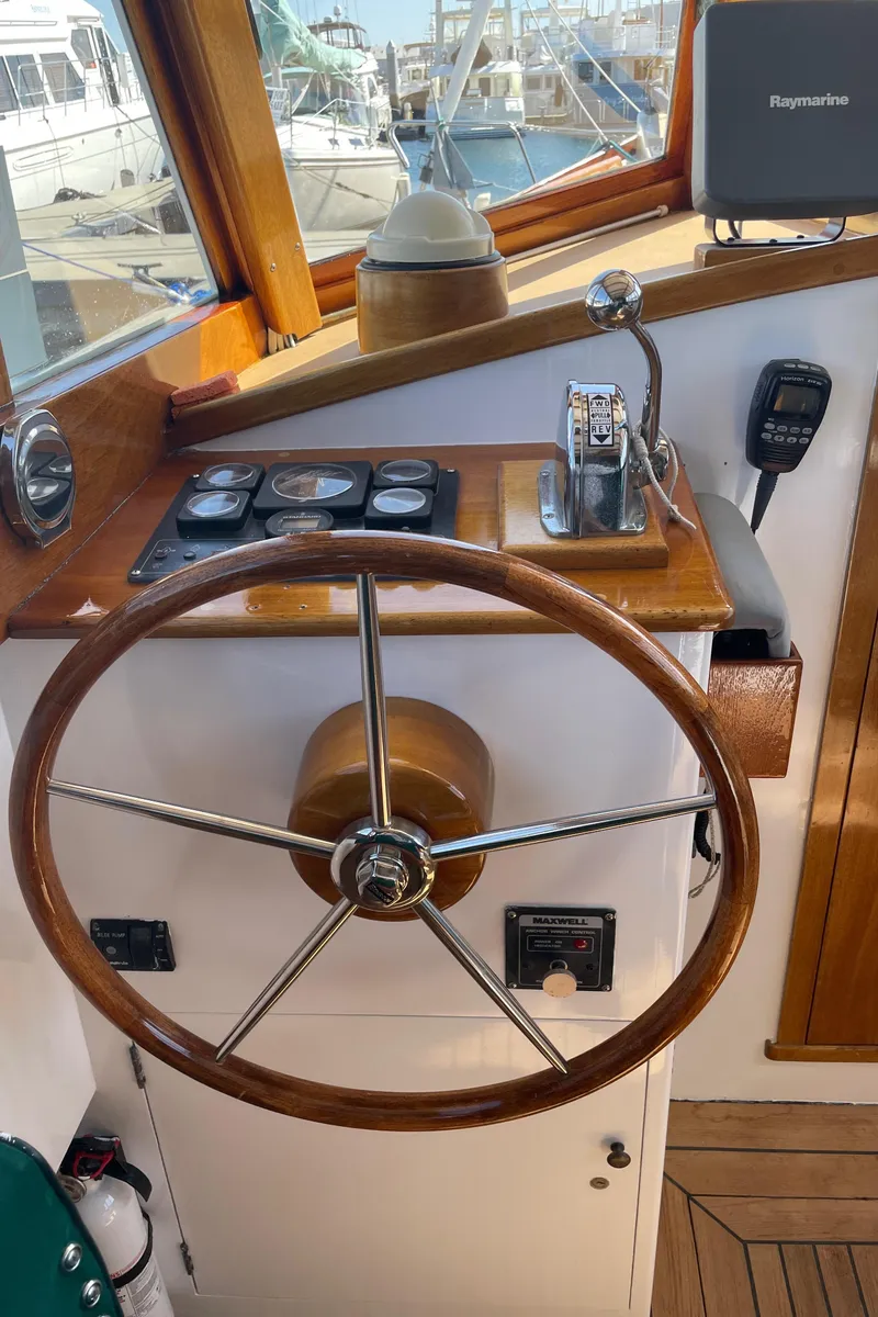 Slide: The Image of Helm of 1996 Downeast 36 Lobster Boat with wooden wheel and navigation controls. - 16