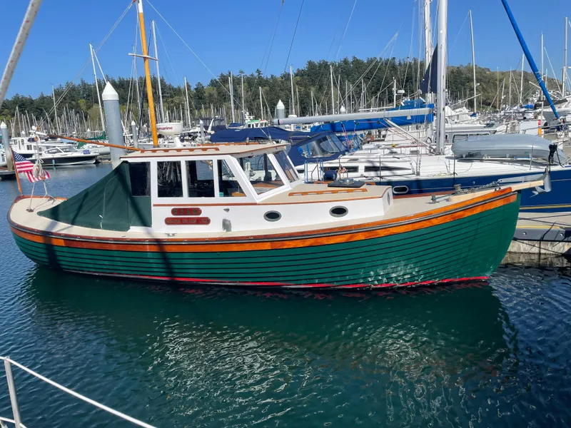 Slide: The Image of 1996 Downeast 36 Lobster Boat docked in a marina, surrounded by sailboats. - 2