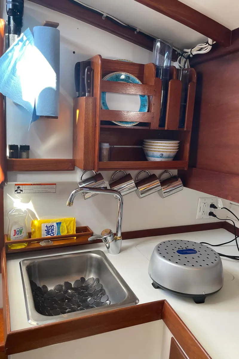 Slide: The Image of Compact kitchen in 1996 Downeast 36 Lobster Boat with sink, dish rack, and countertop appliance. - 26