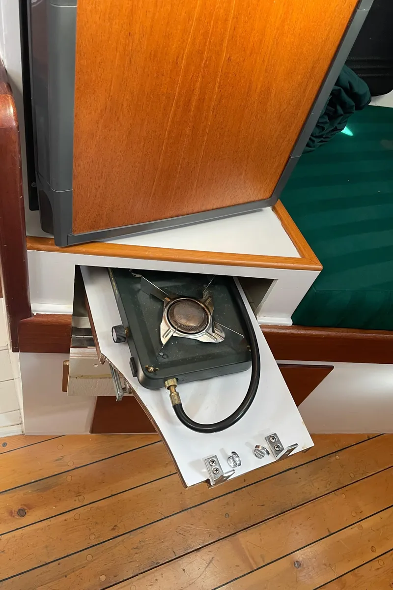 Slide: The Image of 1996 Downeast 36 Lobster Boat interior with pull-out stove and wooden flooring. - 29