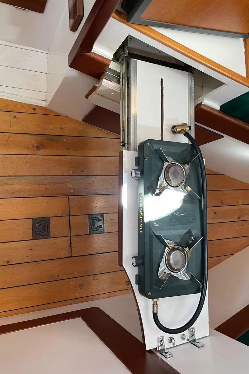 Slide: The Image of 1996 Downeast 36 Lobster Boat interior with wooden flooring and a compact two-burner stove. - 30