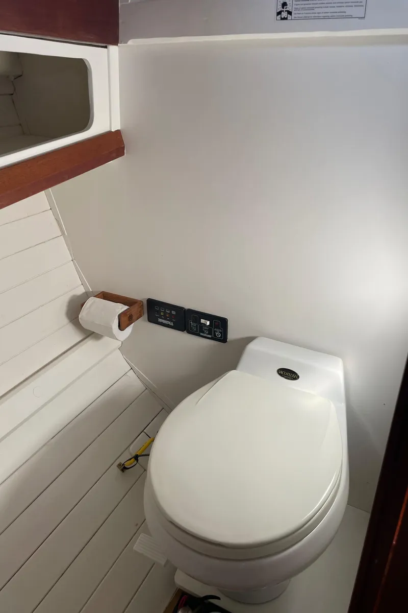 Slide: The Image of 1996 Downeast 36 Lobster Boat interior bathroom with toilet and wooden accents. - 31