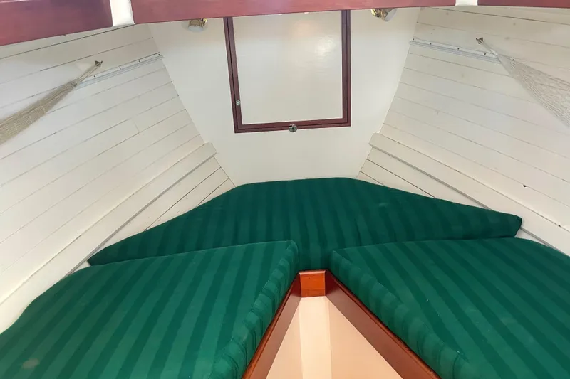 Slide: The Image of 1996 Downeast 36 Lobster Boat interior with green striped cushions. - 34