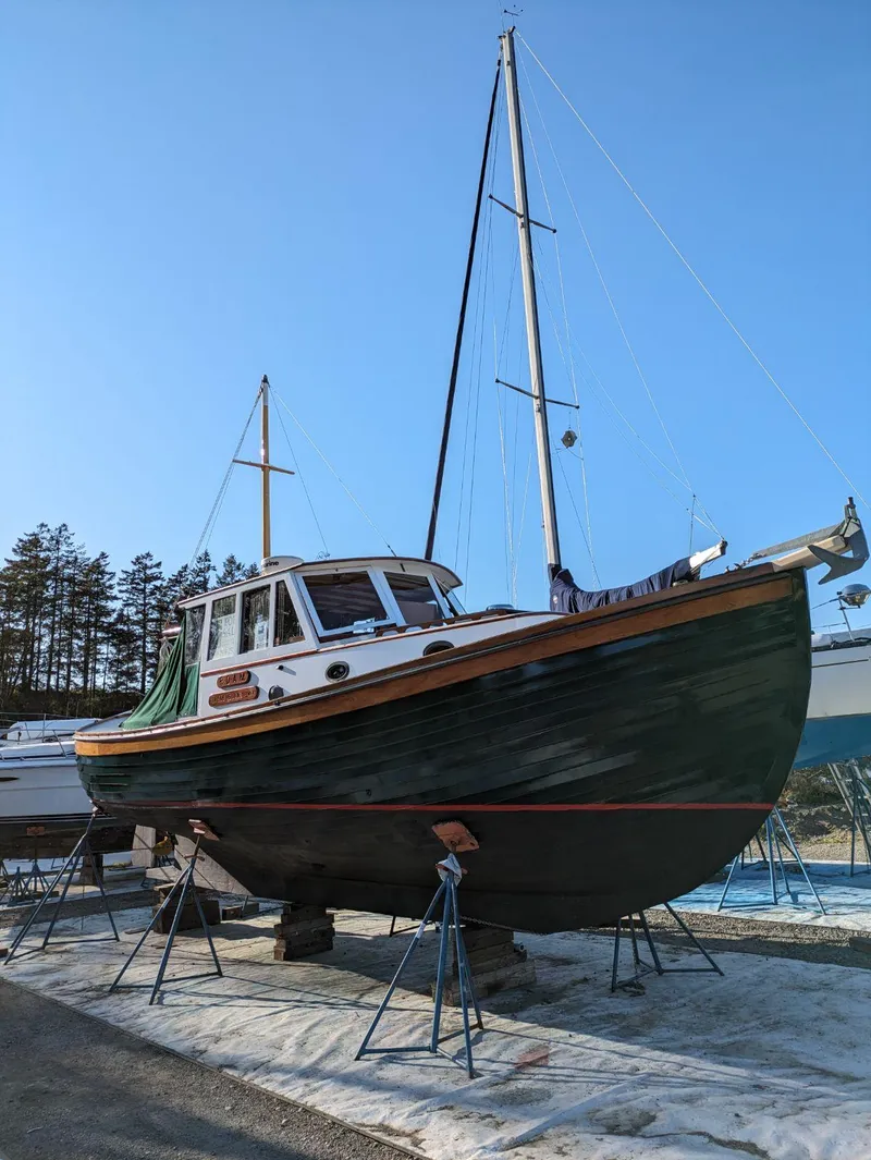 Slide: The Image of 1996 Downeast 36 Lobster Boat on stands, clear sky background. - 36