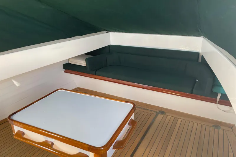 Slide: The Image of 1996 Downeast 36 Lobster Boat interior with wooden flooring and cushioned seating area. - 7