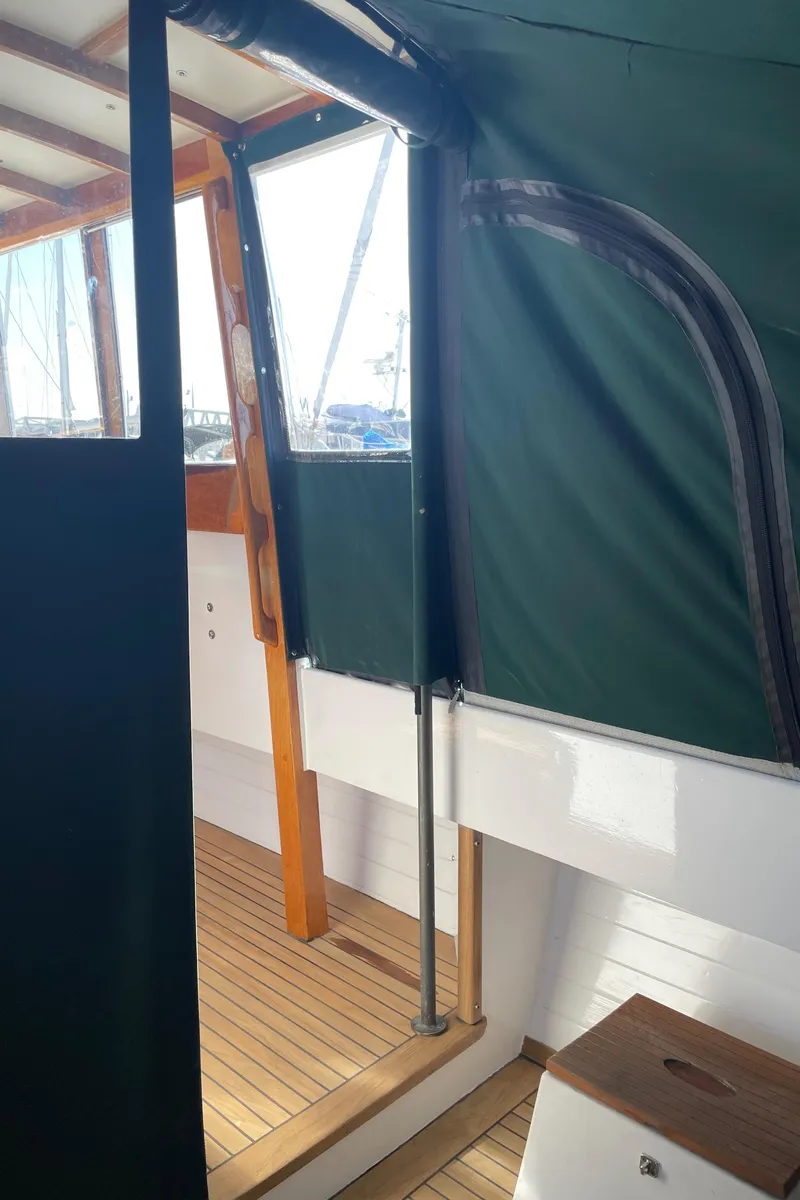 Slide: The Image of Interior view of 1996 Downeast 36 Lobster Boat with wooden flooring and green canopy. - 8