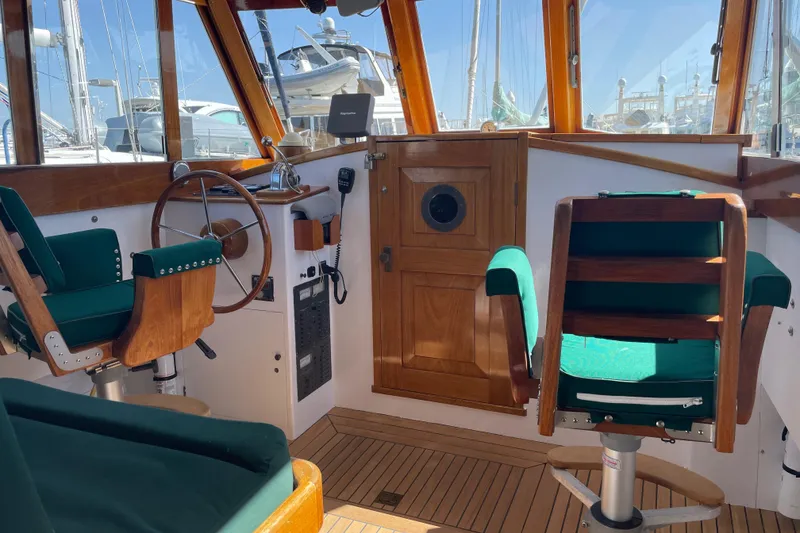 Slide: The Image of 1996 Downeast 36 Lobster Boat interior with wooden accents and green seating. - 9