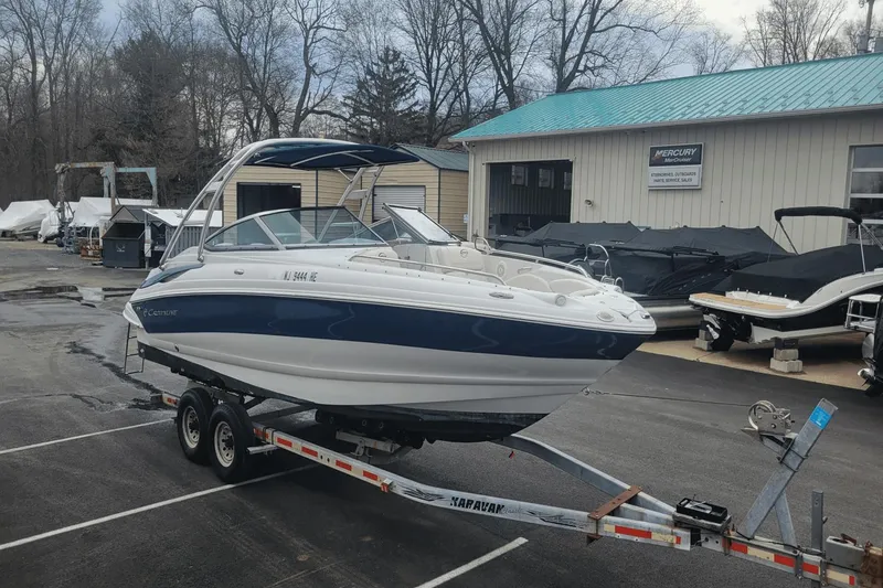 Slide: The Image of 2012 Crownline 265 SS boat on a trailer at a marina. - 0