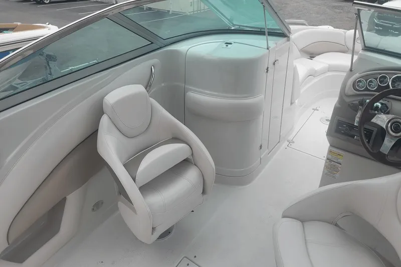 Slide: The Image of Interior of 2012 Crownline 265 SS boat with white leather seats and modern dashboard. - 15