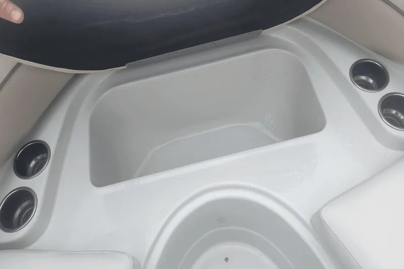 Slide: The Image of Storage compartment and cup holders on a 2012 Crownline 265 SS boat. - 17