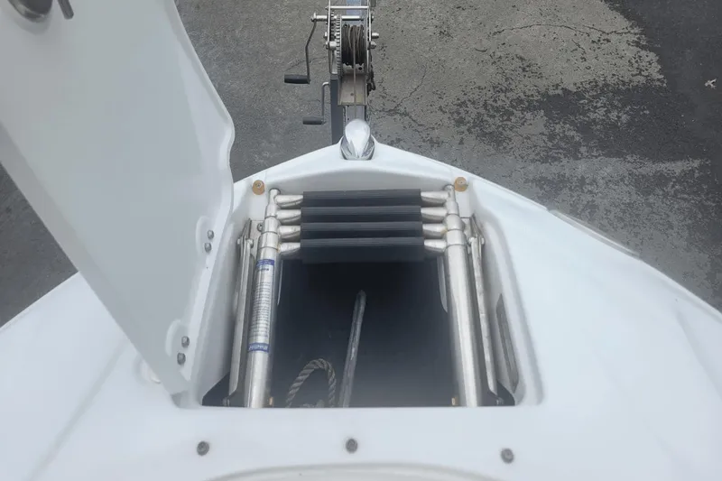 Slide: The Image of Open anchor compartment of a 2012 Crownline 265 SS boat. - 18