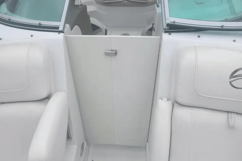 Slide: The Image of Interior of 2012 Crownline 265 SS boat with white seating and closed door. - 19