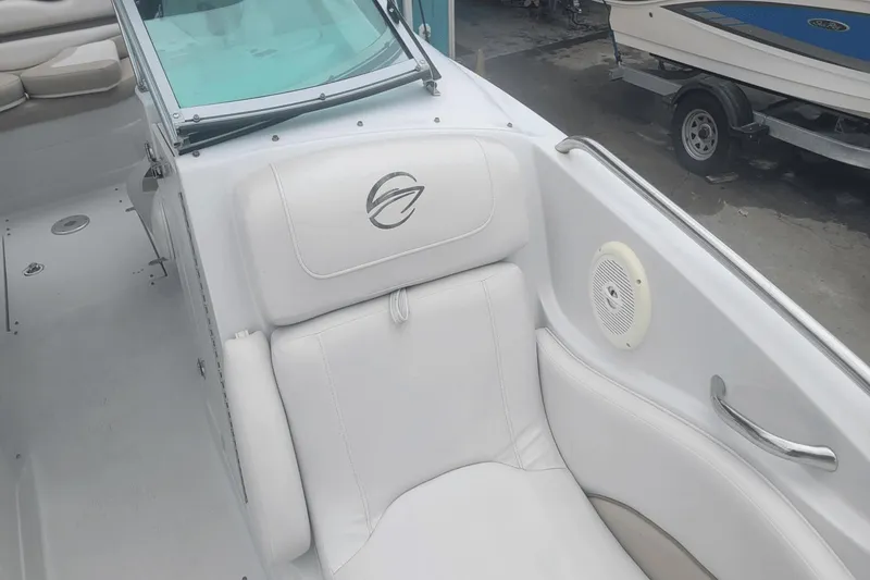 Slide: The Image of 2012 Crownline 265 SS boat interior with white leather seating and speaker. - 20
