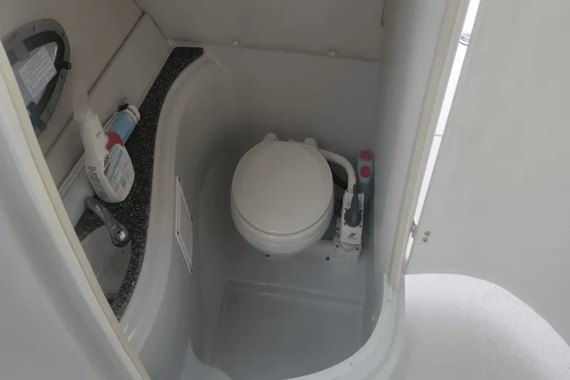 Slide: The Image of Compact bathroom in 2012 Crownline 265 SS boat with toilet and sink. - 21