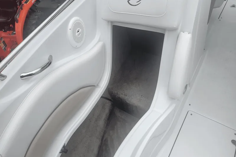 Slide: The Image of Interior of a 2012 Crownline 265 SS boat showing seating and storage area. - 23