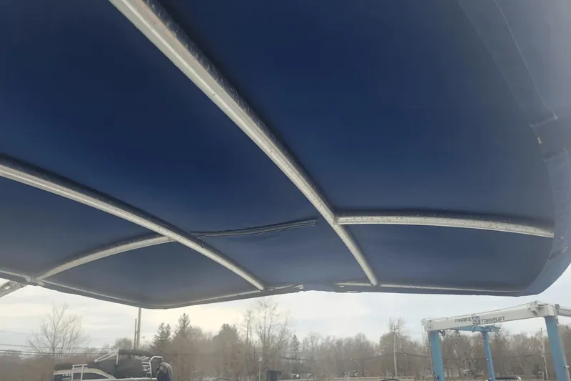 Slide: The Image of Blue canopy of a 2012 Crownline 265 SS boat with metal frame. - 25