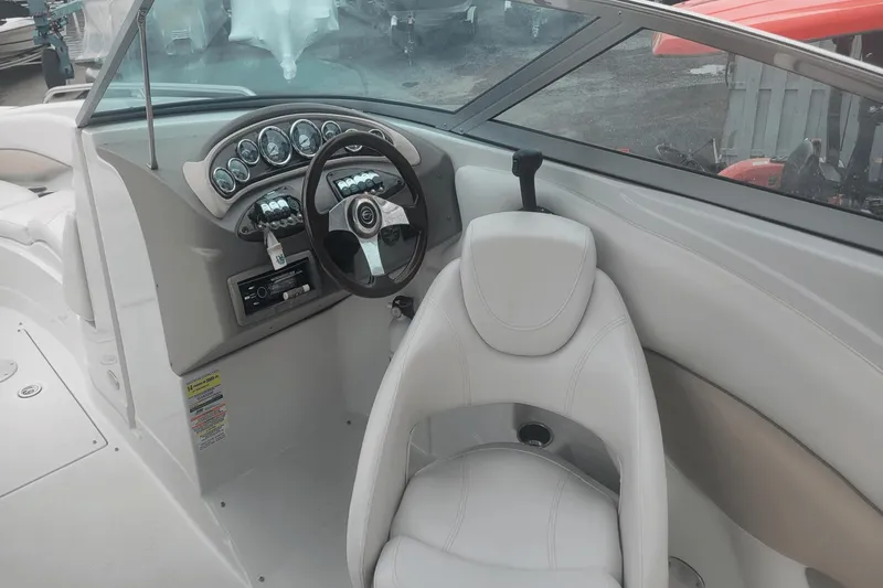 Slide: The Image of 2012 Crownline 265 SS boat cockpit with steering wheel and captain's chair. - 5