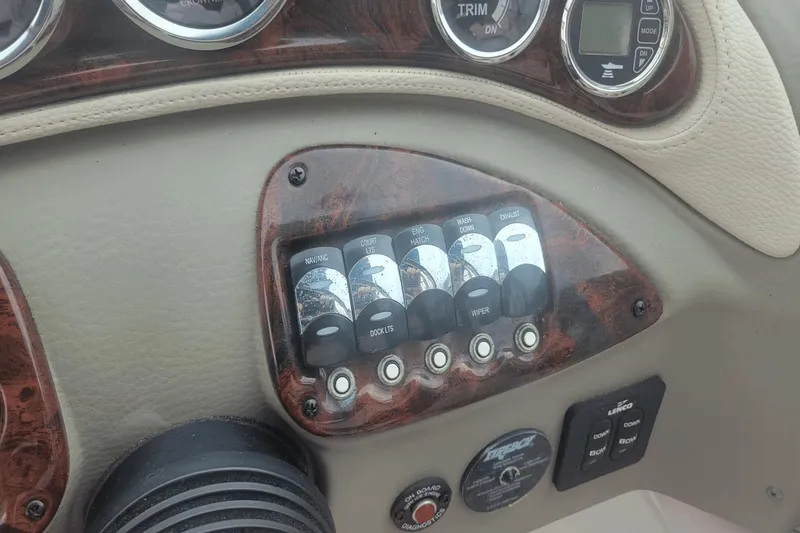 Slide: The Image of Dashboard controls of a 2012 Crownline 265 SS boat with wood trim accents. - 7
