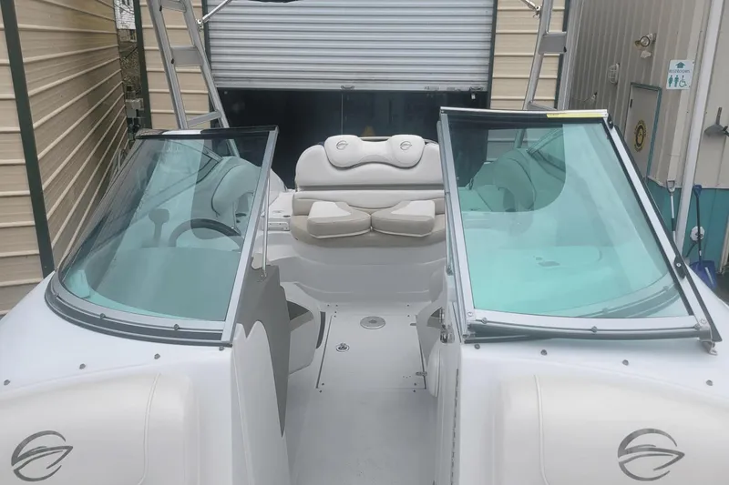 Slide: The Image of 2012 Crownline 265 SS boat interior with white and beige seating. - 9