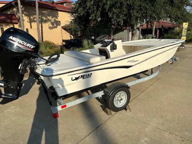 Slide: The Image of 2023 Mako Pro Skiff 13 CC boat on trailer with Mercury outboard motor. - 3