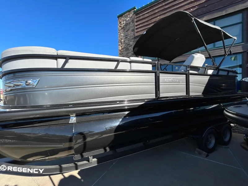 Slide: The Image of 2023 Regency 230 DL3 pontoon boat with black and gray exterior. - 1