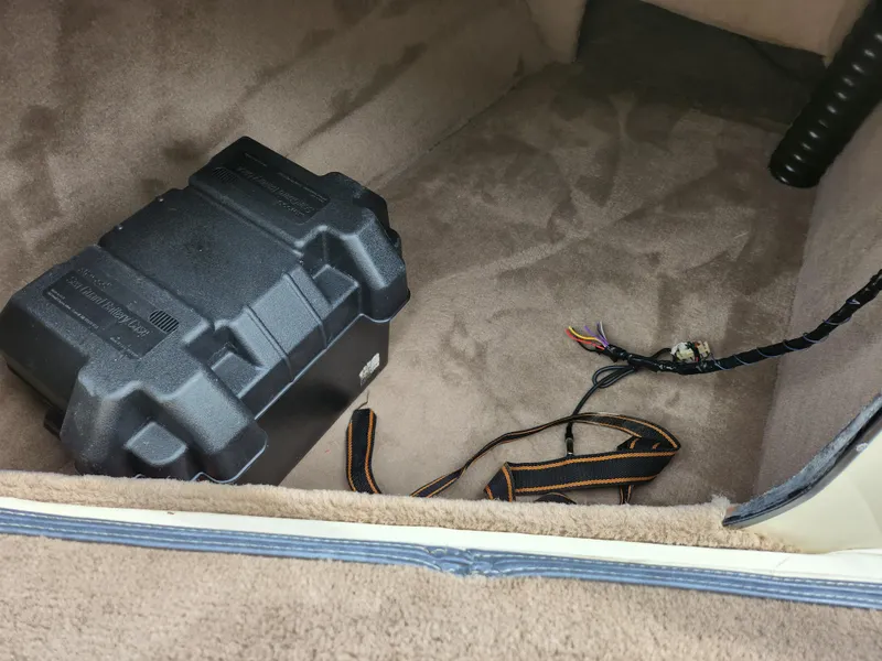 Slide: The Image of Battery compartment of a 1998 Tigé PRE 2200I boat with wiring and straps. - 11