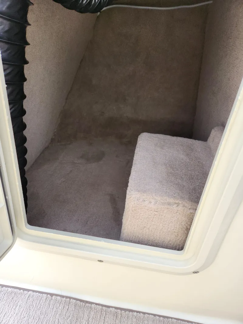 Slide: The Image of 1998 Tigé PRE 2200I boat interior cabin with carpeted flooring. - 12