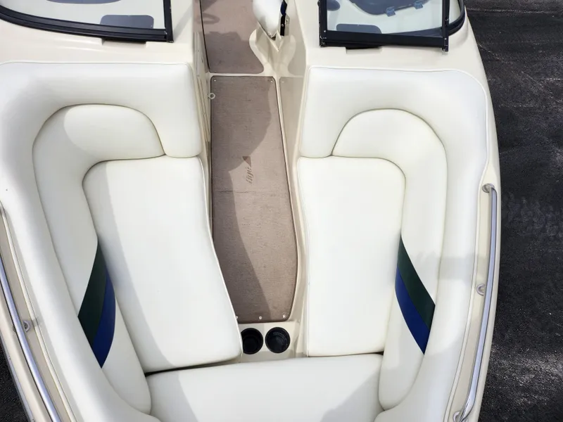 Slide: The Image of 1998 Tigé PRE 2200I boat interior with white seating and cup holders. - 14