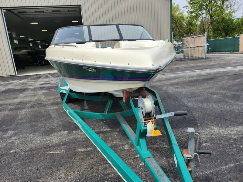 Slide: The Image of 1998 Tigé PRE 2200I boat on a trailer outside a storage facility. - 3