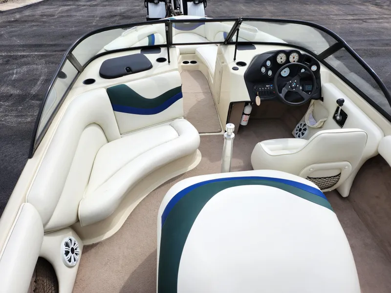 Slide: The Image of 1998 Tigé PRE 2200I boat interior with beige seating and blue-green accents. - 8