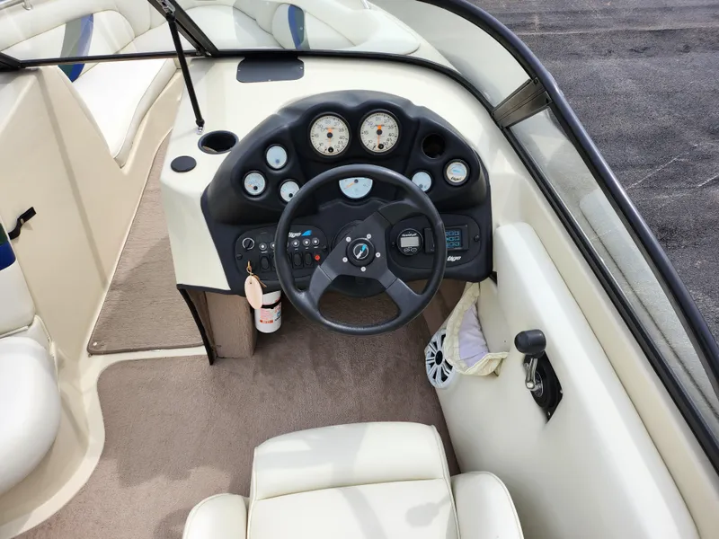 Slide: The Image of 1998 Tigé PRE 2200I boat dashboard with steering wheel and gauges. - 9