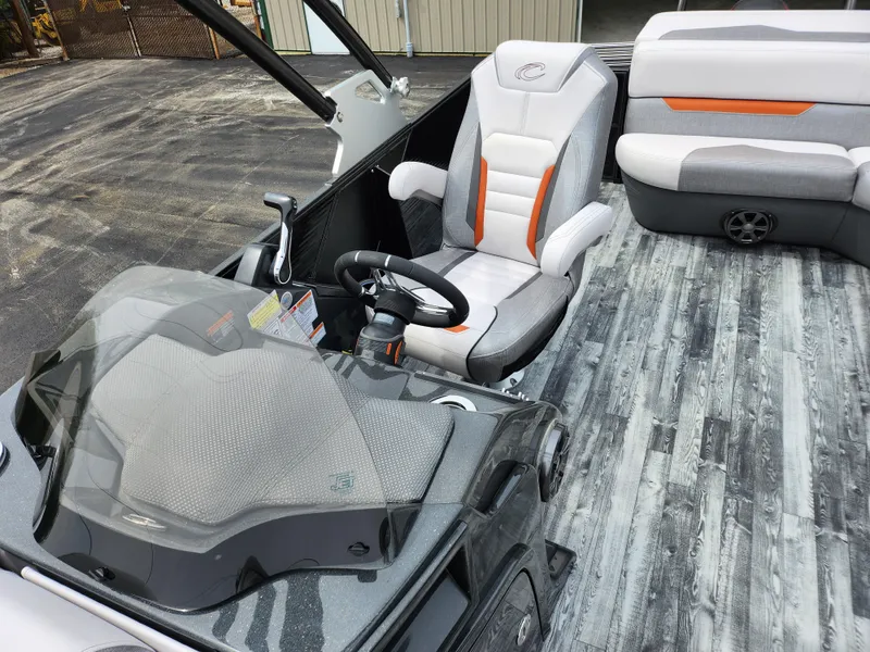 Slide: The Image of 2019 Crest Caliber 230 SL boat interior with modern seating and steering console. - 13