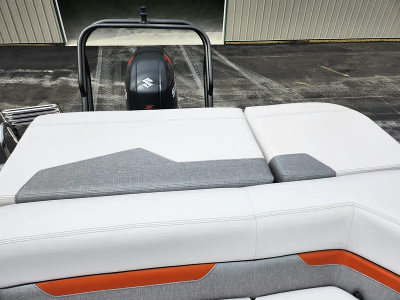 Slide: The Image of 2019 Crest Caliber 230 SL boat with Suzuki outboard motor and cushioned seating. - 16