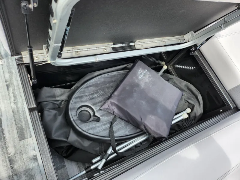 Slide: The Image of Storage compartment of 2019 Crest Caliber 230 SL boat with accessories. - 17