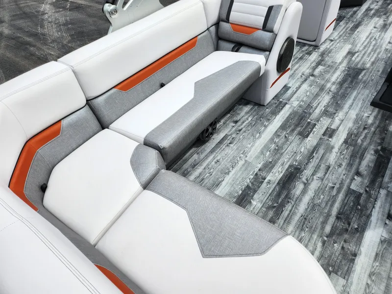 Slide: The Image of 2019 Crest Caliber 230 SL boat interior with white, gray, and orange seating. - 19