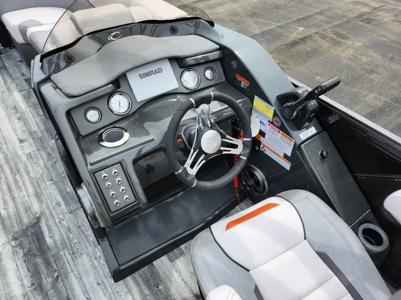 Slide: The Image of 2019 Crest Caliber 230 SL boat dashboard with steering wheel and controls. - 21