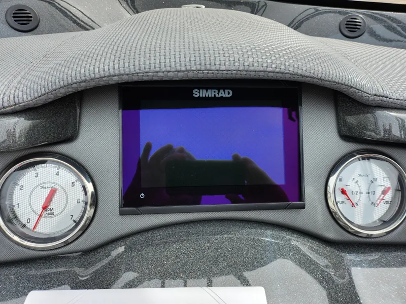 Slide: The Image of Dashboard of 2019 Crest Caliber 230 SL with Simrad display and gauges. - 23